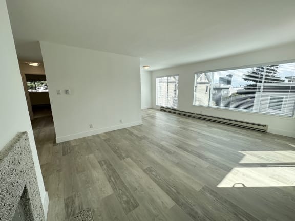 an empty living room with a large window
