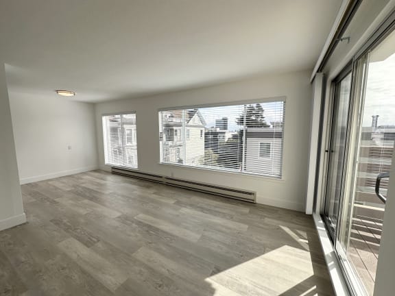 a bedroom with a large window and a sliding glass door