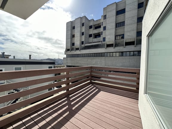 a view from a balcony of a building with a blue sky in the background