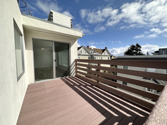 a view of a balcony with a door and a blue sky in the background