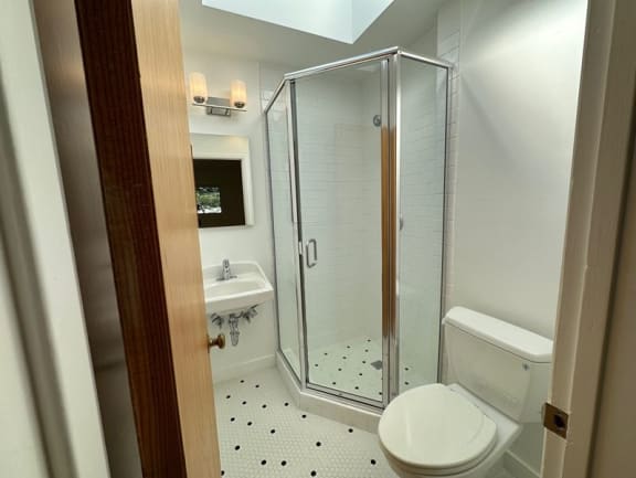 a bathroom with a toilet sink and shower