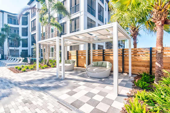A patio area with a white pergola at Tapestry Nona in Orlando, FL