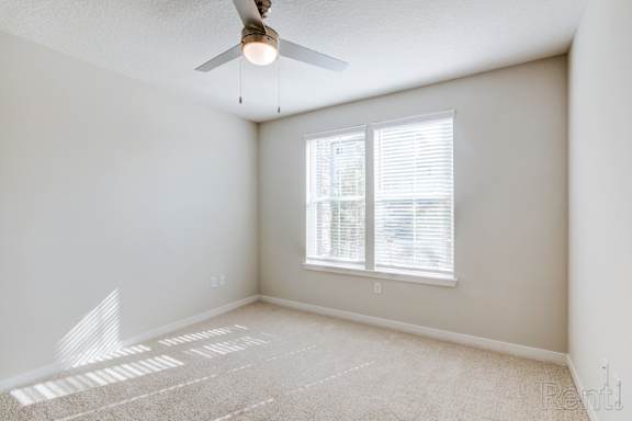 A room with a window and a fan.