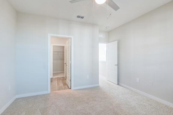 bedroom with carpet and en-suite bathroom at Tapestry Nona Apartments in Orlando, FL