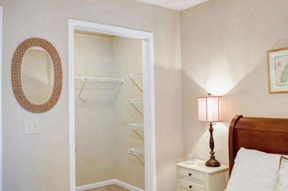 a bedroom with a closet and a bed and a mirror