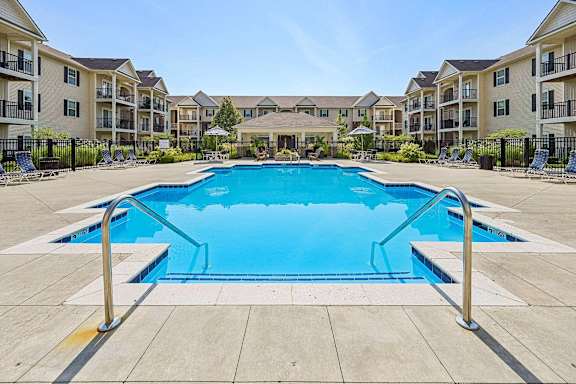 A large swimming pool in the middle of a residential area.