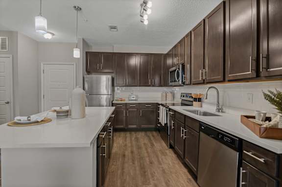 A kitchen with brown cabinets and a white counter.