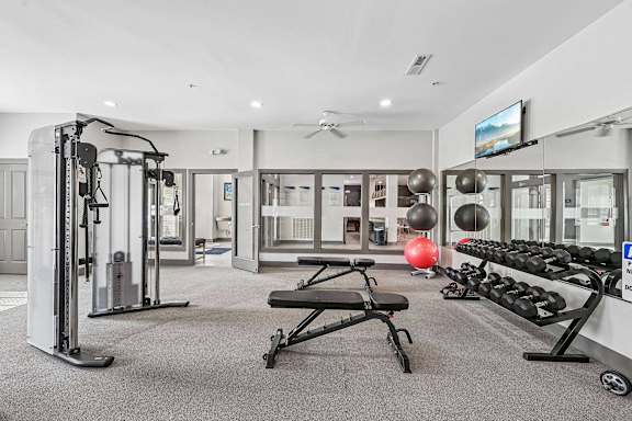 A well-equipped home gym with a variety of exercise equipment.