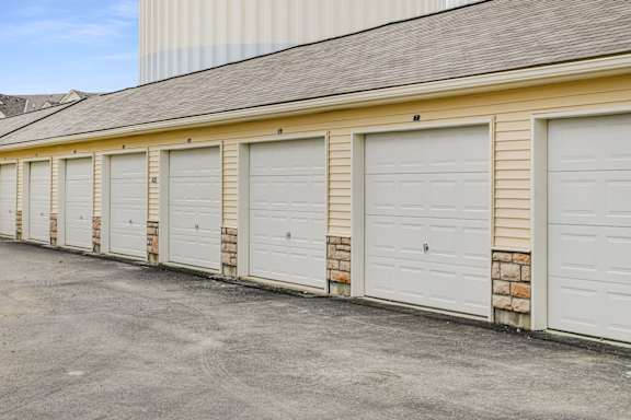 A row of white garage doors are closed.