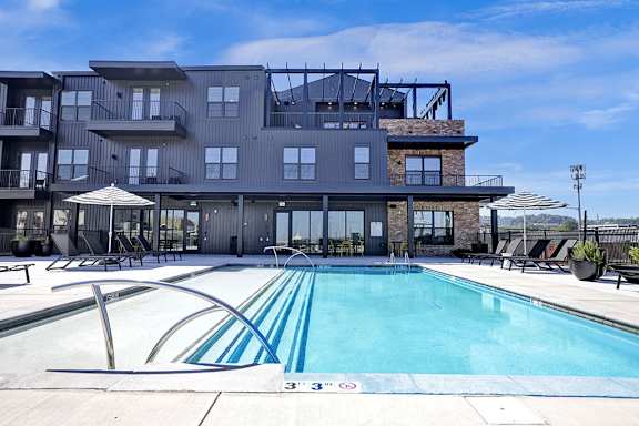 Resort-Style Rooftop Pool and Umbrellas at Artisan Flats Apartments in Birmingham, AL
