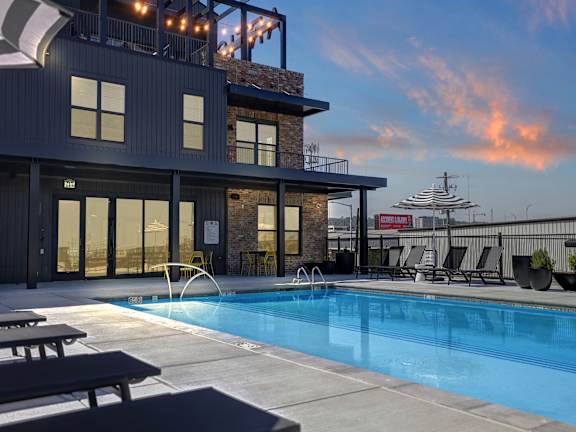 Twilight Pool View with Soft Seating at Artisan Flats Apartments in Birmingham, AL