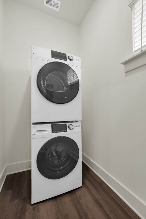 A white front load washing machine in a room at Turnberry Park Luxury Rental Homes
