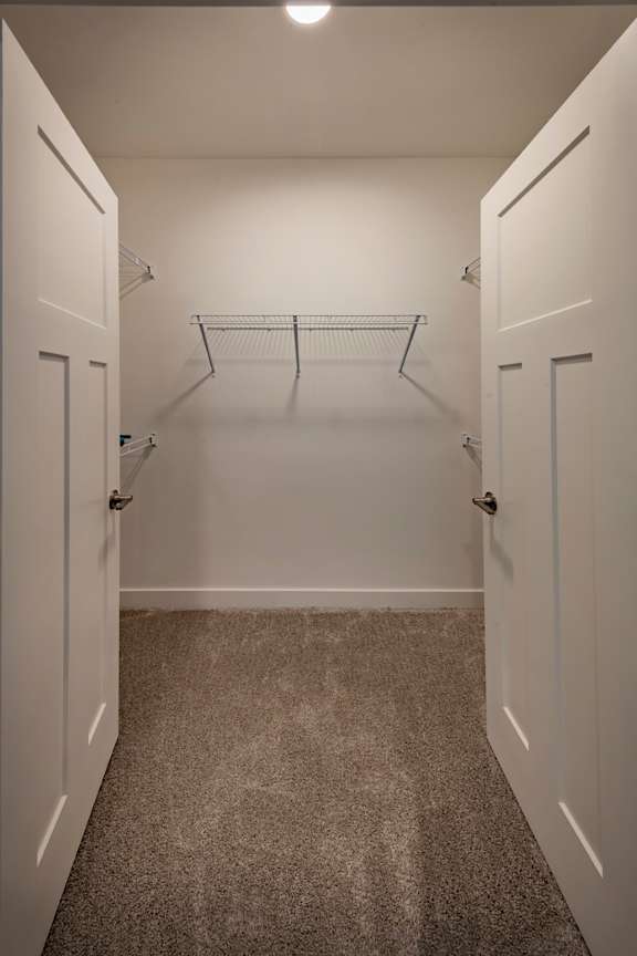 Spacious closet space with french doors and wire shelving at Wesley Place Apartments in Indianapolis, IN
