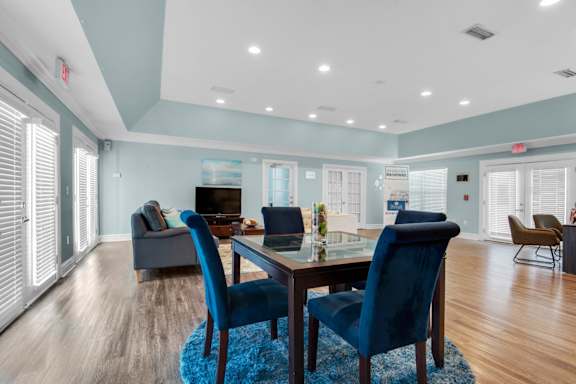 Clubhouse with multiple seating arrangements and a lounge area at Crystal Lake in Pensacola, Florida.