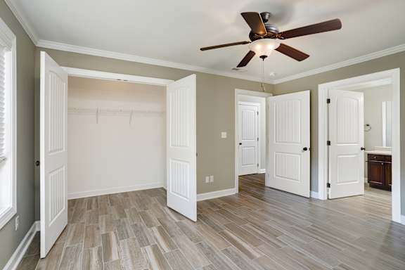 bedroom with ceiling fan and wood floors at The Oakley at Deerfield Apartments in Florence, AL