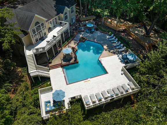 An aerial view of the pool and pool deck surrounded by trees at Summerchase at Riverchase in Hoover, Alabama