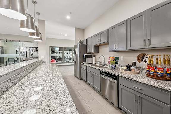 A kitchen with granite countertops and stainless steel appliances.