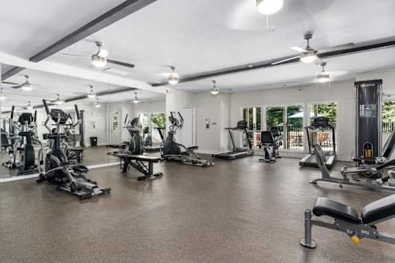 Fitness center with ceiling fans and natural light at Summerchase at Riverchase in Hoover, Alabama