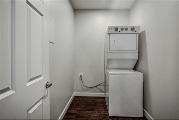 a white laundry room with a washer and dryer in it