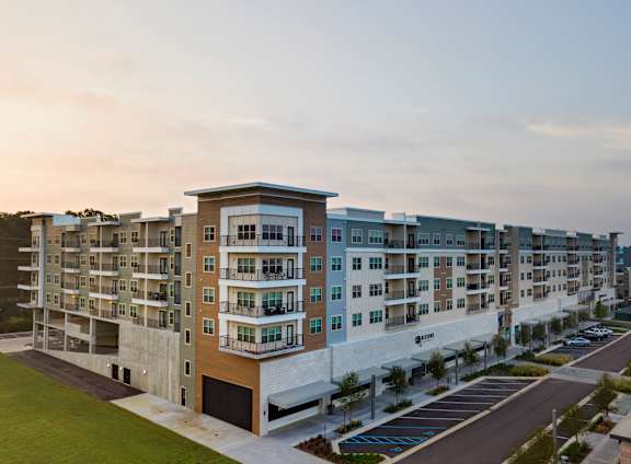 A large apartment complex with multiple buildings and parking lots.