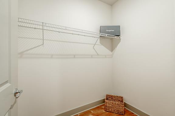 a walk in closet with a wire shelf at Anthem Luxury Homes and Apartment Rentals in Huntsville, AL