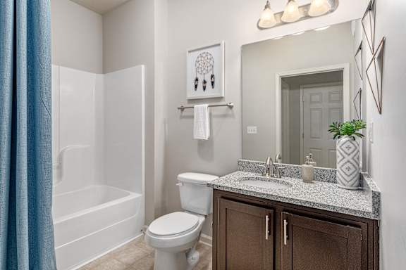 A bathroom with a white toilet, a white sink, and a white bathtub.
