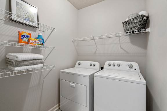A small laundry room with a washer and dryer.