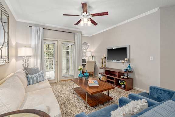 A living room with a white couch and a blue couch.