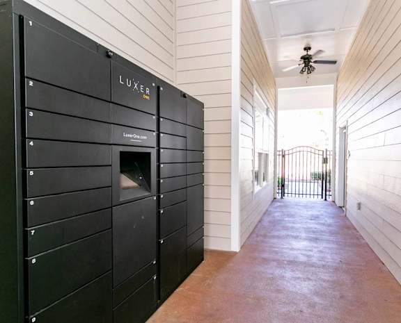 A black safe with the word LUXER on it is in a room.