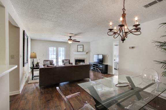 a living room with a glass table and chairs