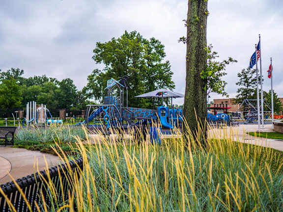 a playground at a park with trees and benches