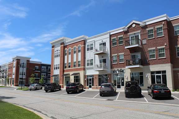 a city street with cars parked in front of a building