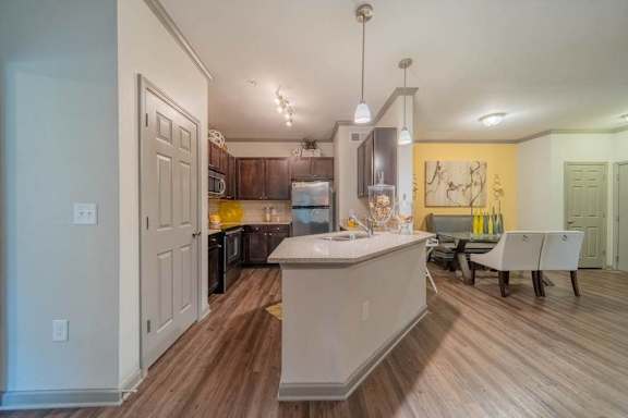 an open kitchen and living room with a table and chairs