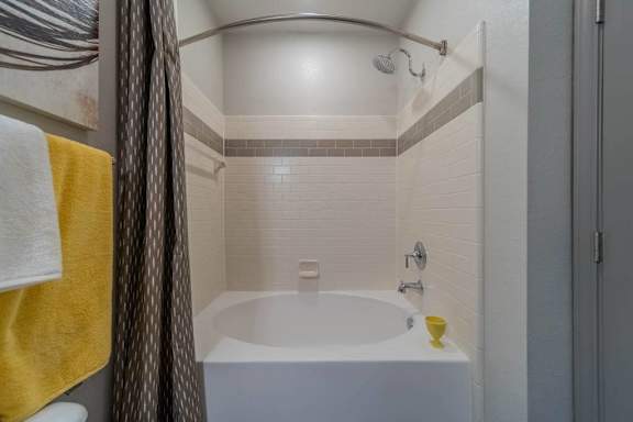 a bathroom with a tub and a shower curtain