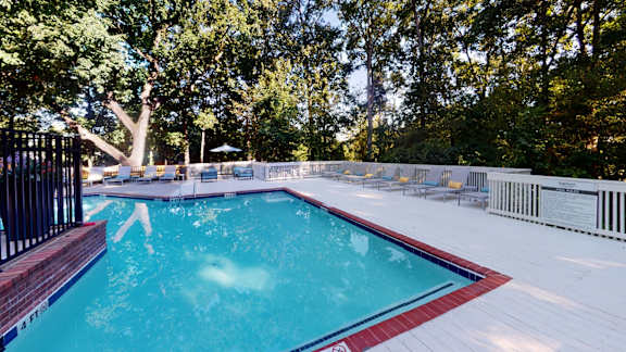 Sparkling pool with expansive sundeck and chaise lounges at Summerchase at Riverchase in Hoover, AL