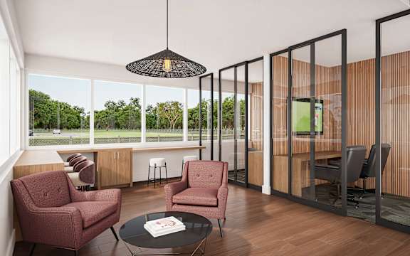 A modern living room with a view of the trees outside the large windows.