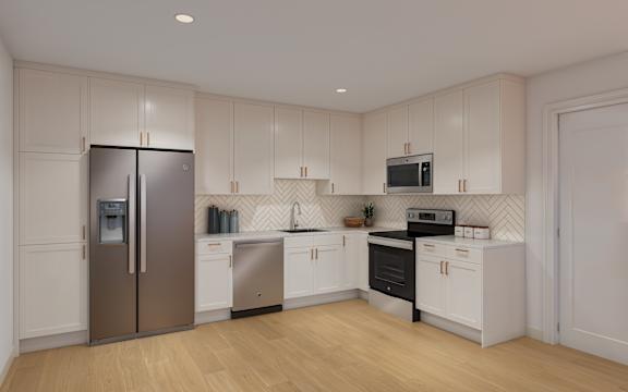 A kitchen with white cabinets and a stainless steel refrigerator.