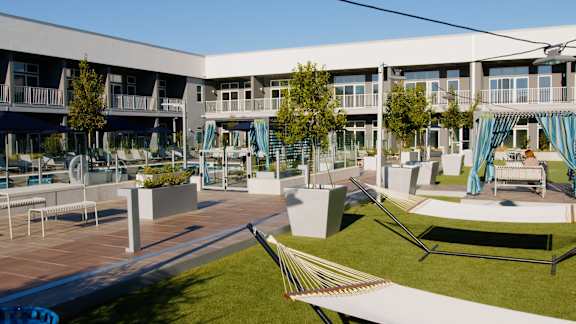a rendering of an outdoor area with hammocks and lawn furniture at 20 Midtown, Birmingham, Alabama