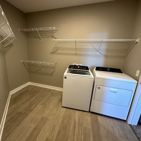 A laundry room with a washer and dryer at The Fitzroy Apartments in Birmingham, AL