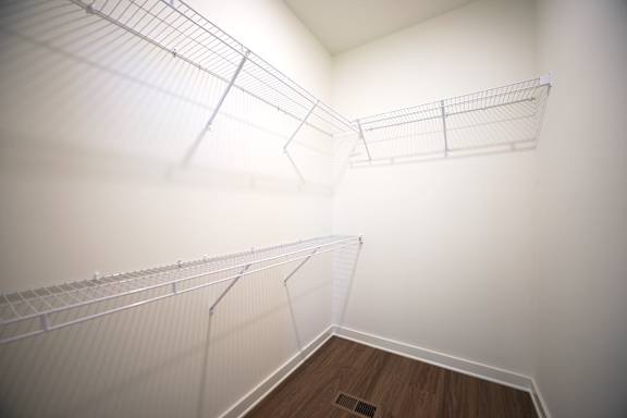 Walk-in closet with shelving at Wesley Place Apartments in Birmingham, AL