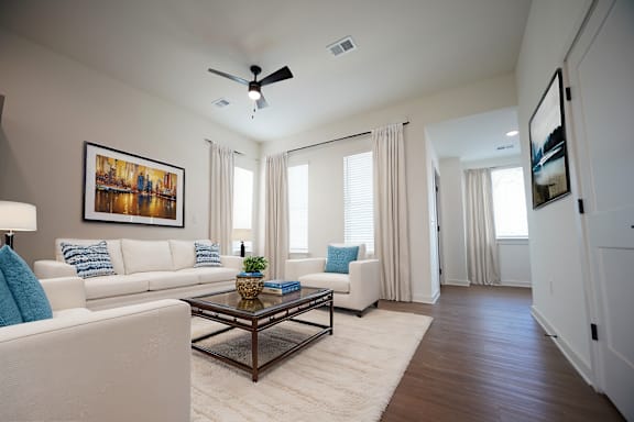 Living room with ceiling fan and wood-style flooring at West Row Lofts and Townhomes in Birmingham, AL
