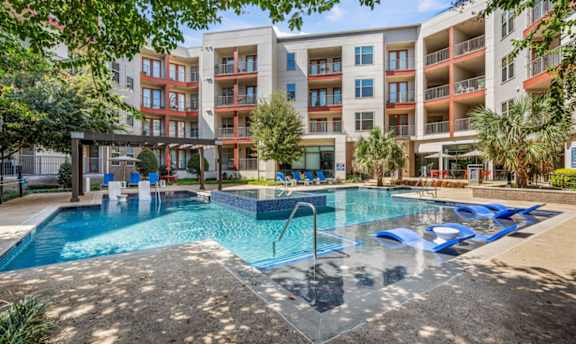 Resort style pool with sun loungers and modern apartments at The Mark at Midtown Apartments, Texas, 75231
