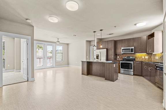 Open concept kitchen with dark wood cabinets at Matilda at Lower Greenville Apartments, Texas, 75206