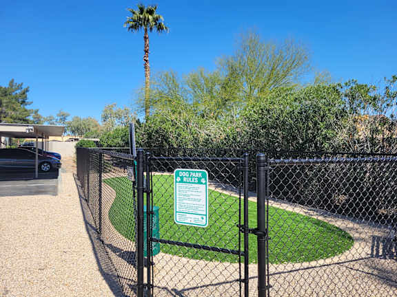 Fenced dog park with artificial turf and rules sign at Gentrys Walk Apartments, Mesa, 85204