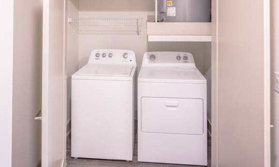 Two white washing machines in an apartment at Avion at West Lemmon apartments