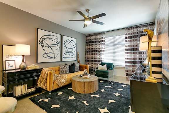 Stylish den with teal accent chair and abstract art at The Mark at Midtown Apartments, Texas, 75231