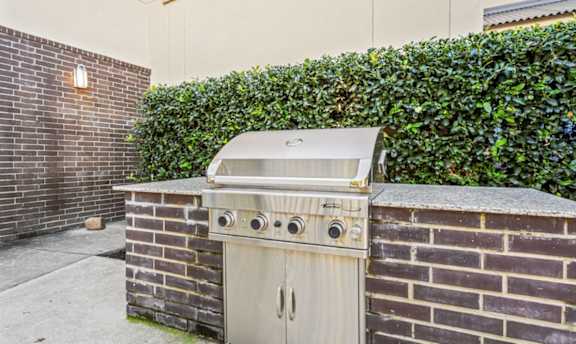 Outdoor grilling area with built in barbecue station at Matilda at Lower Greenville Apartments, Dallas, Texas