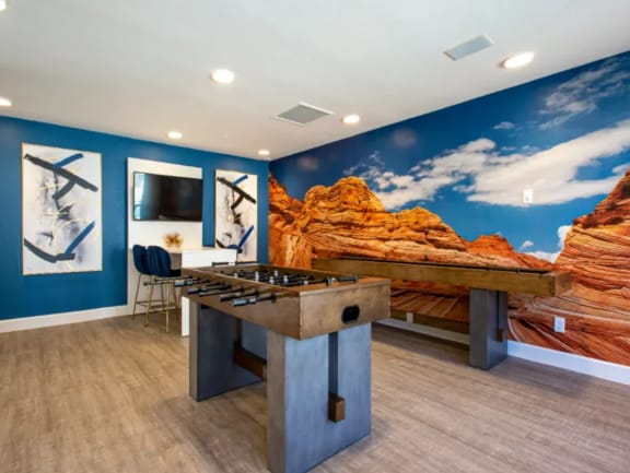 Resident Game Room with Mountain View Wall Paper, Foosball Table, Shuffleboard Table,  and Plank Flooring at Enclave at Paradise Valley in Phoenix, AZ
