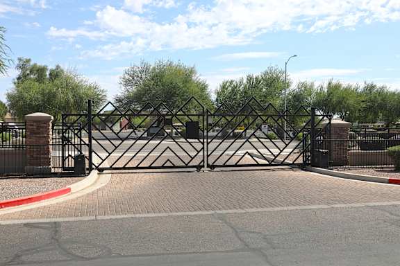 A black gate with a diamond pattern is closed.