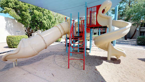 Playground with spiral slides and climbing structure at Gentrys Walk Apartments, Arizona, 85204